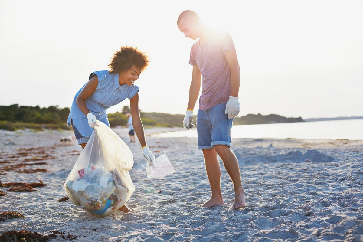 Coupe collecting trash on the beach
