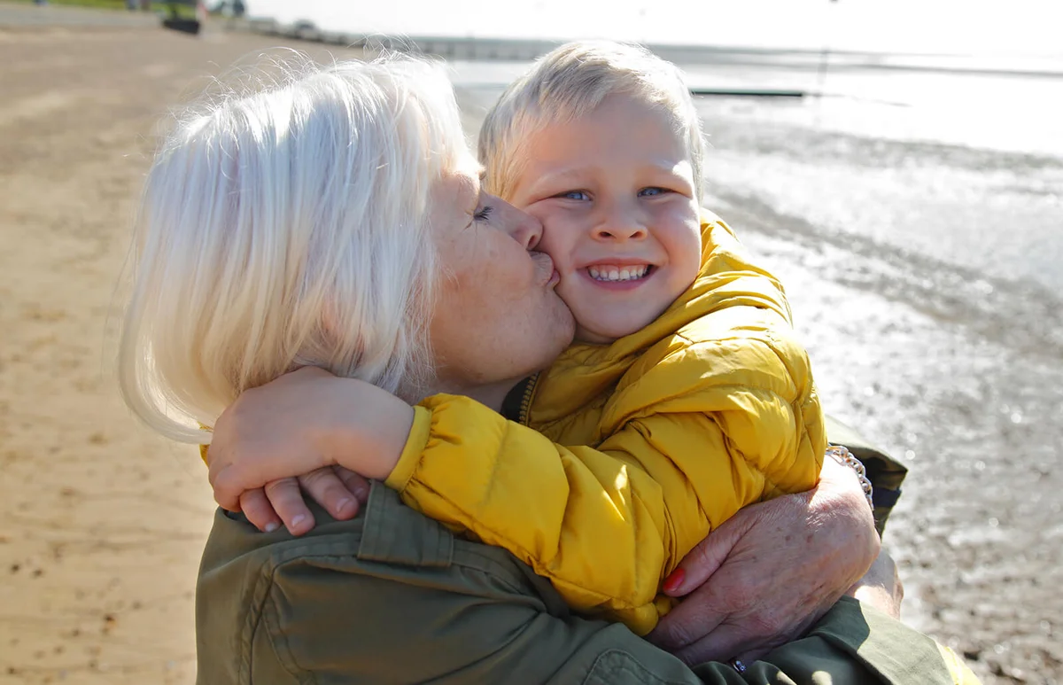 Grandmother kissing grandson on the cheek