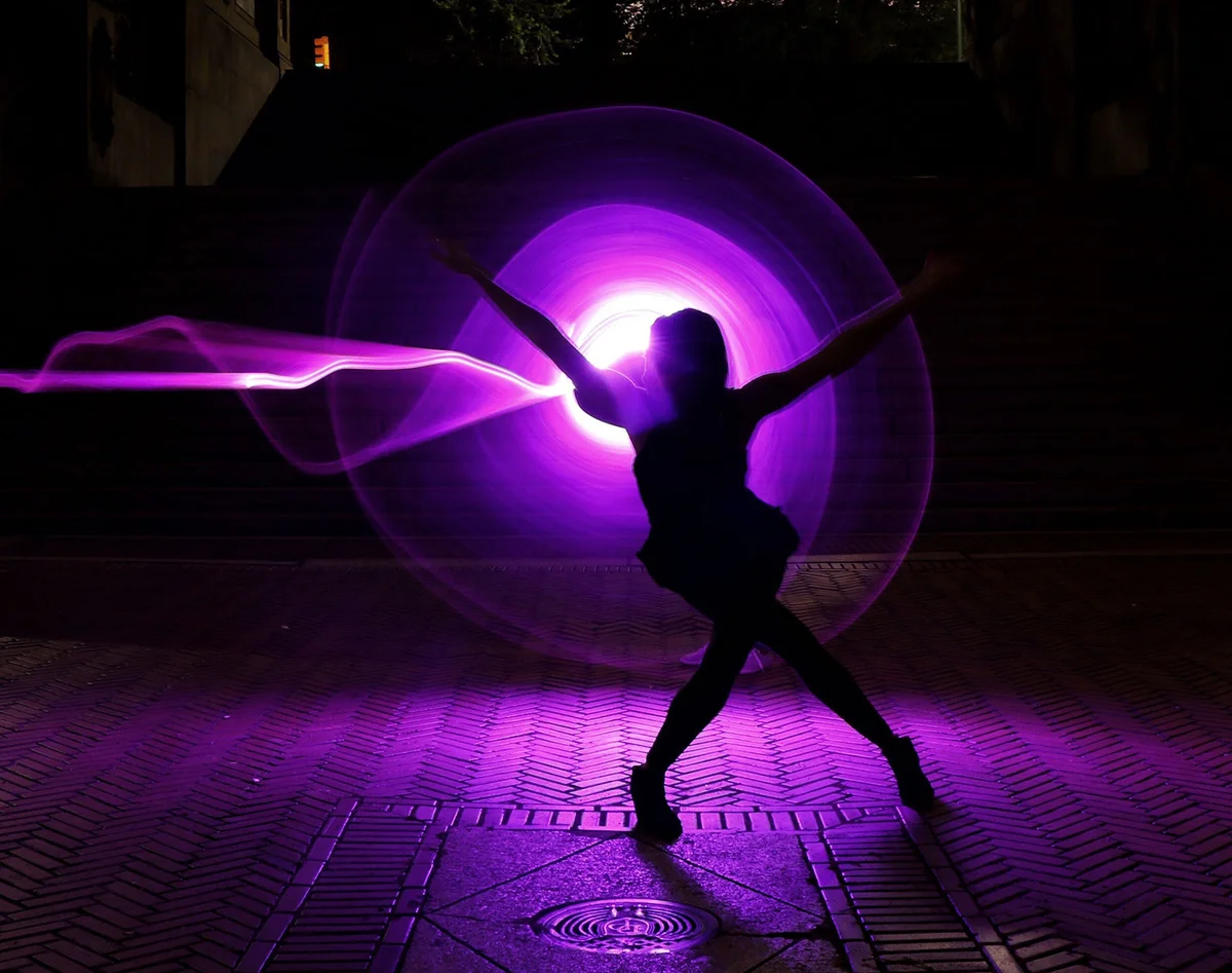 Woman dancing in purple light