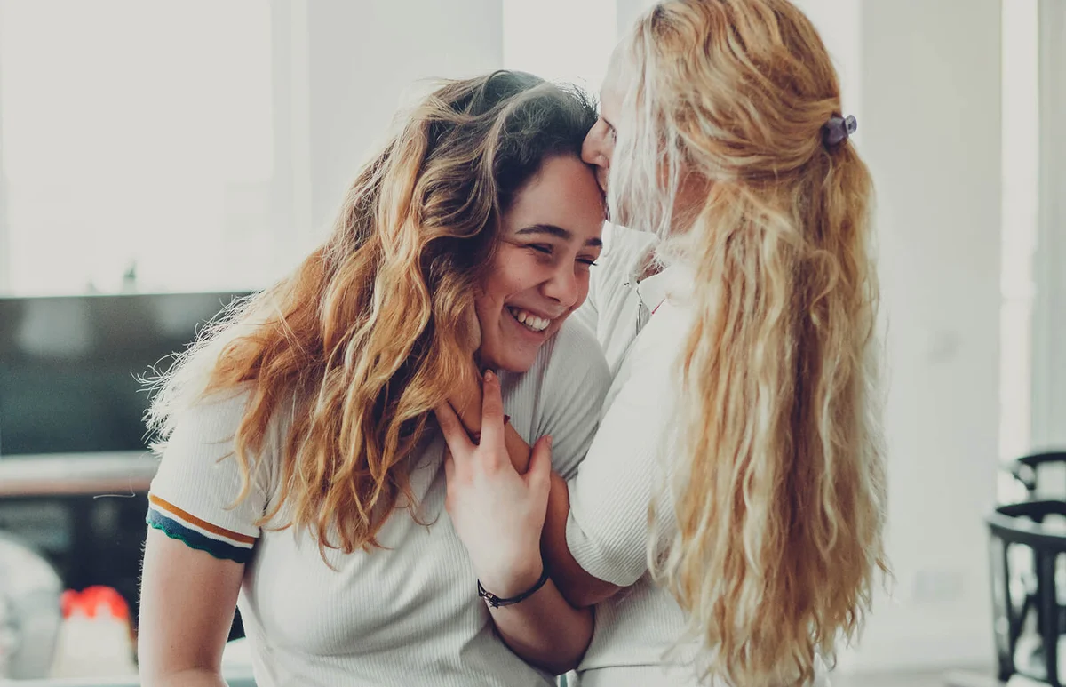Mother kissing her daughter