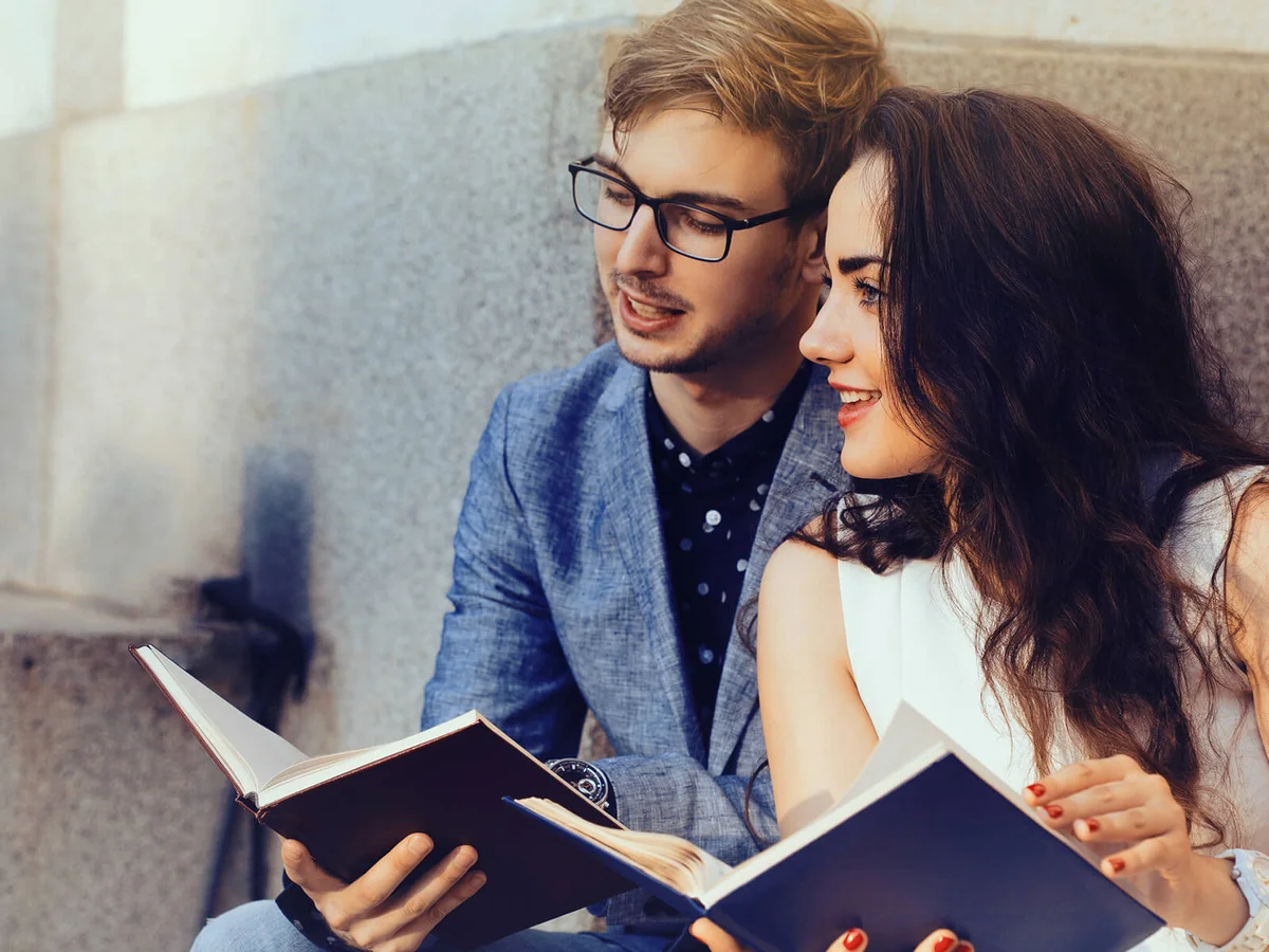 Happy couple reading books