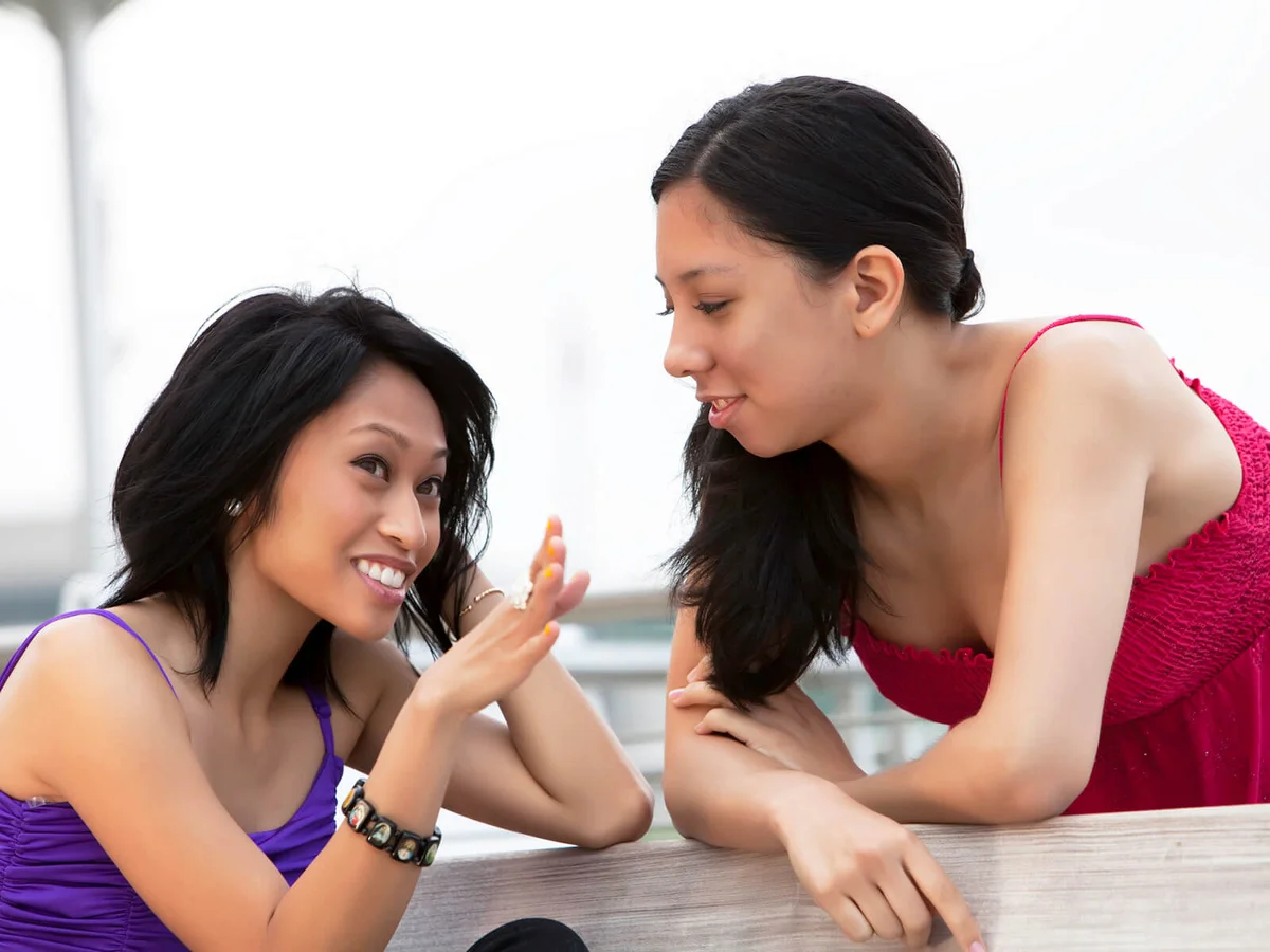 Two friends talking and laughing