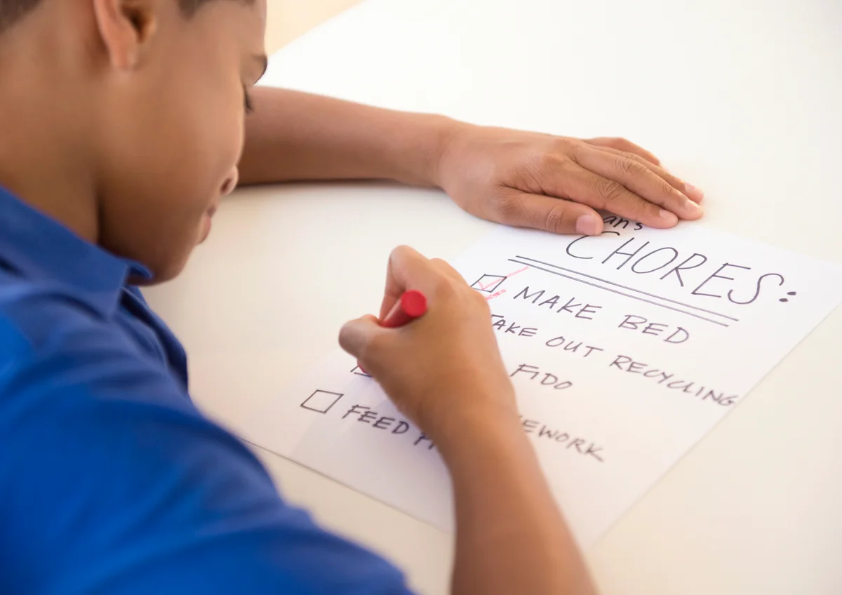 Boy checking off chore list
