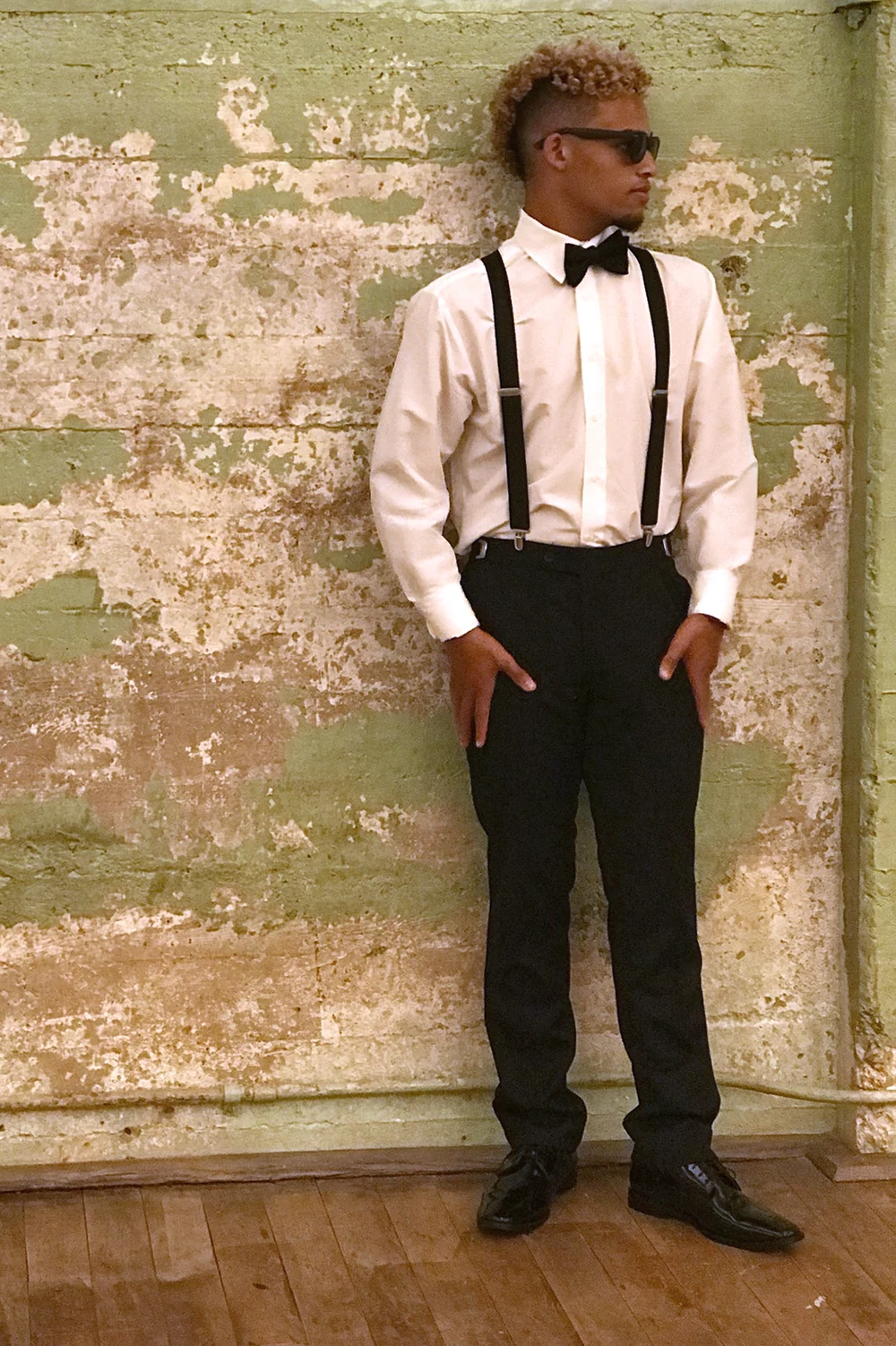 Young man in suspenders and bow tie