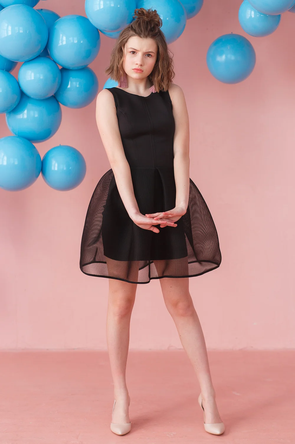 Teen girl wearing black cocktail dress
