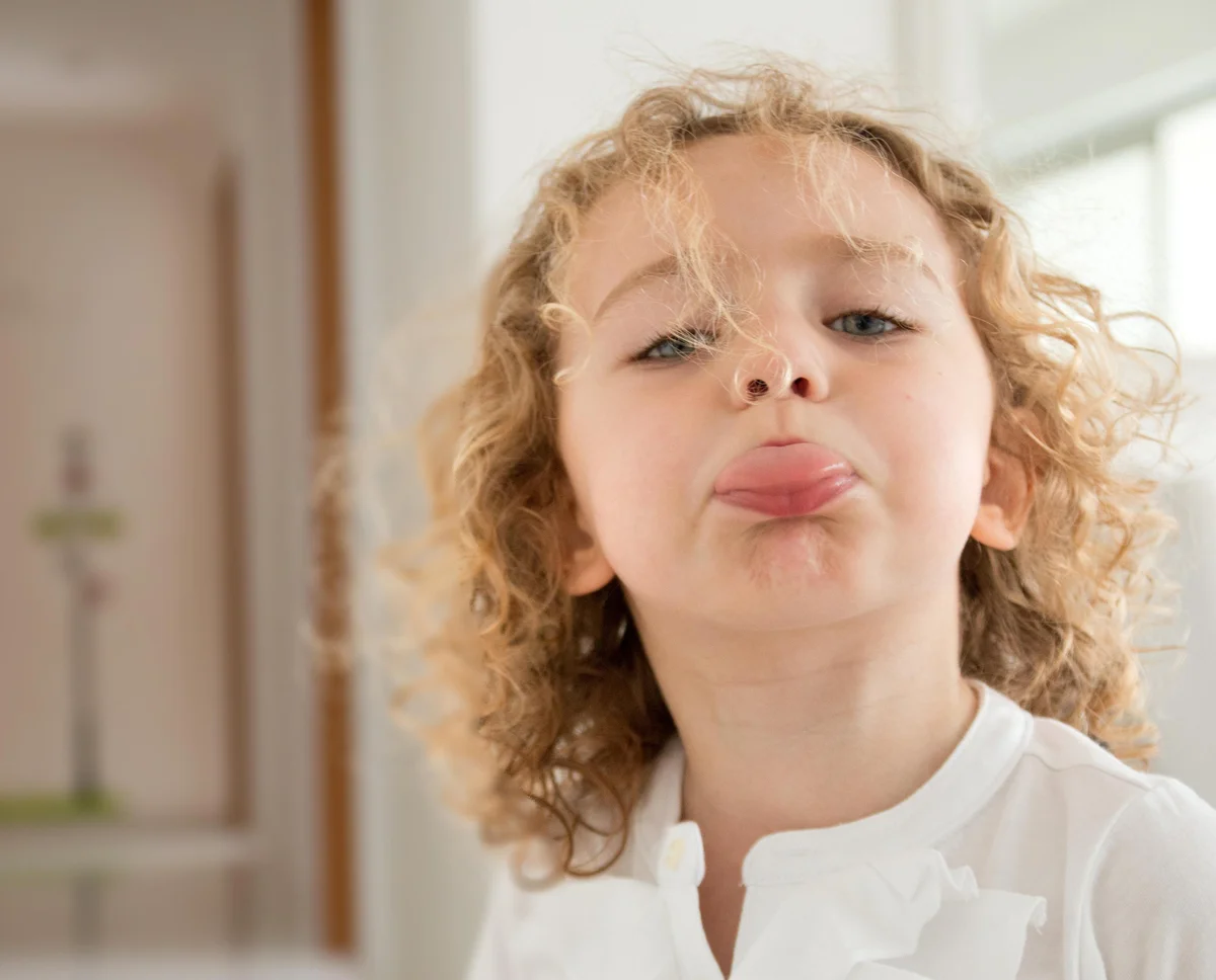 child sticking out tongue