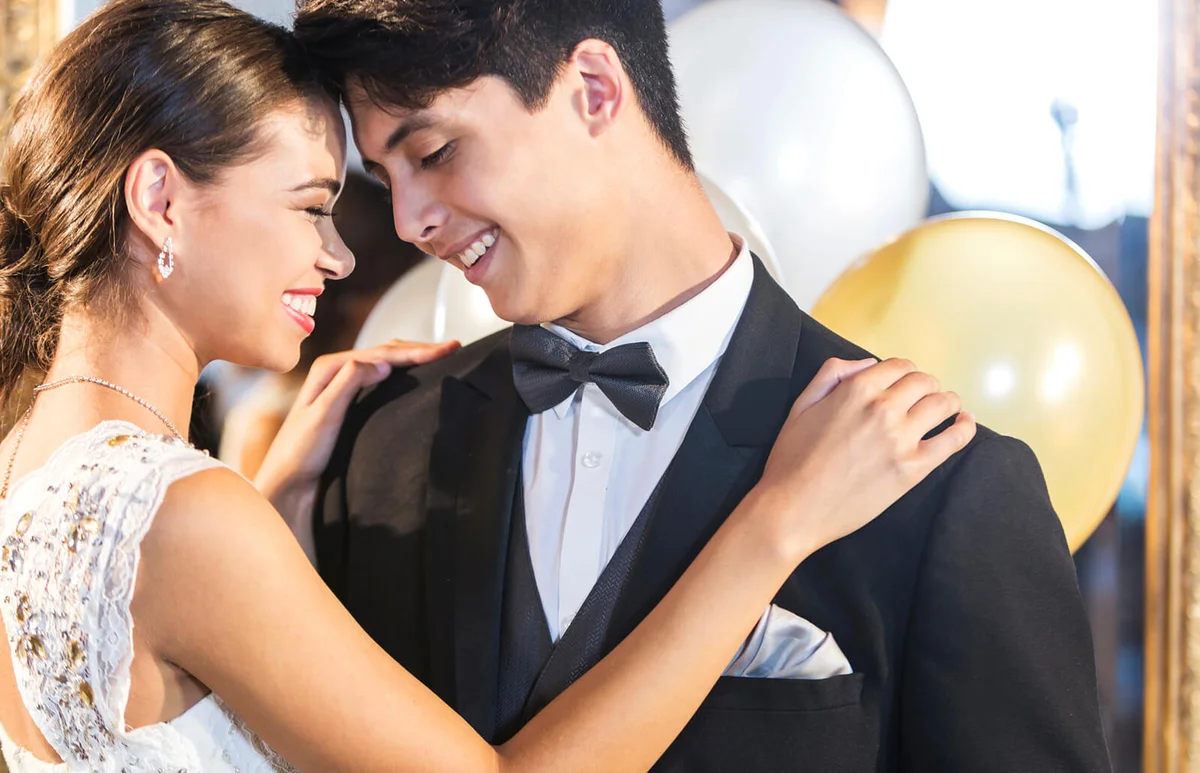 Teenage couple dancing at prom
