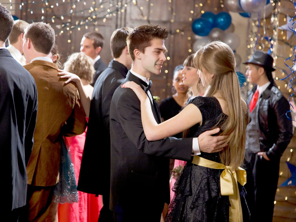 Teenage couples dancing at prom