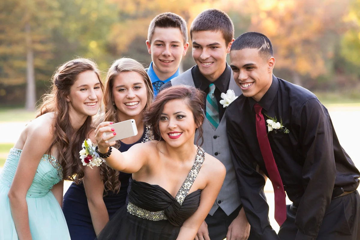 Teenagers dressed up taking selfie