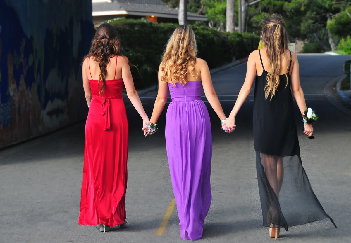 Shot from back of three girls holding hands