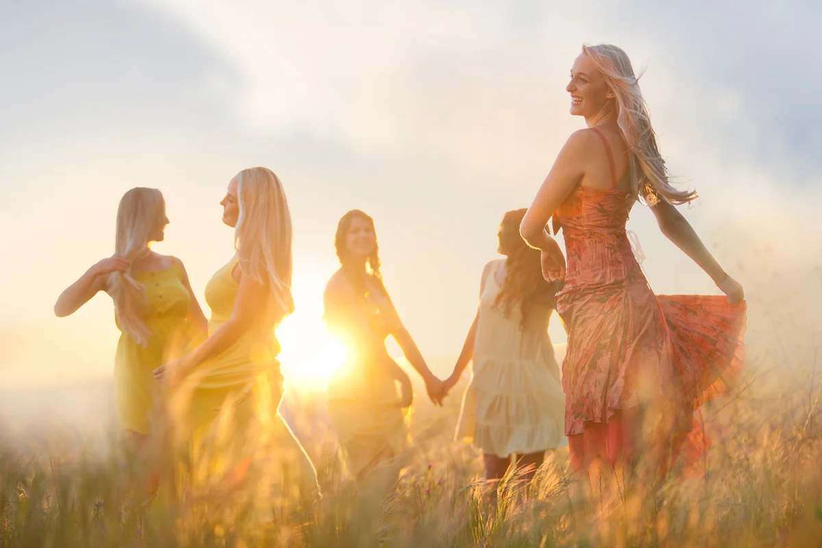 Friends dancing in meadow