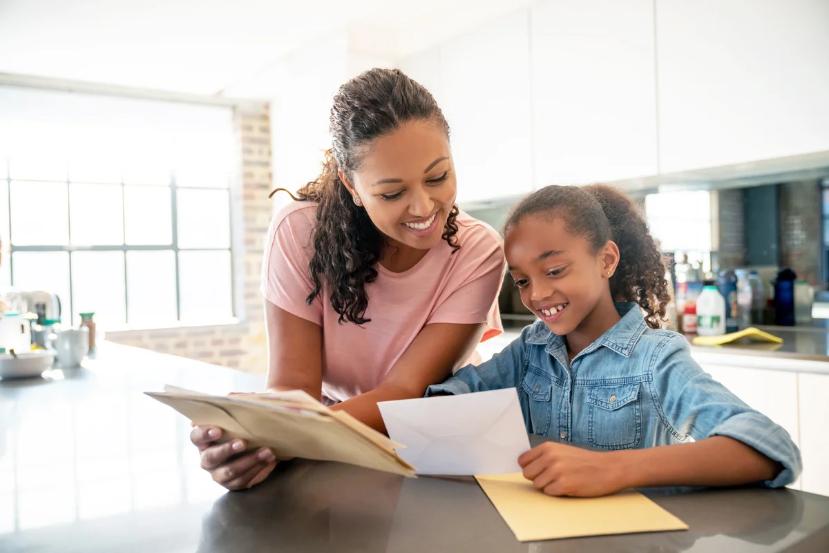 Mother and daughter checking the mail at home