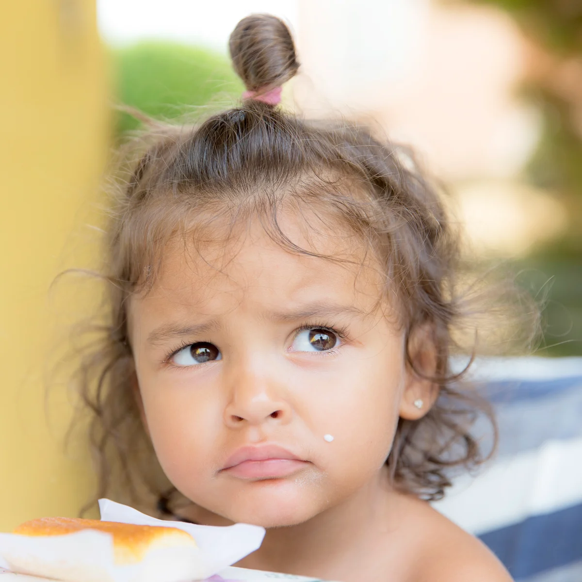 Unhappy little girl with breakfast