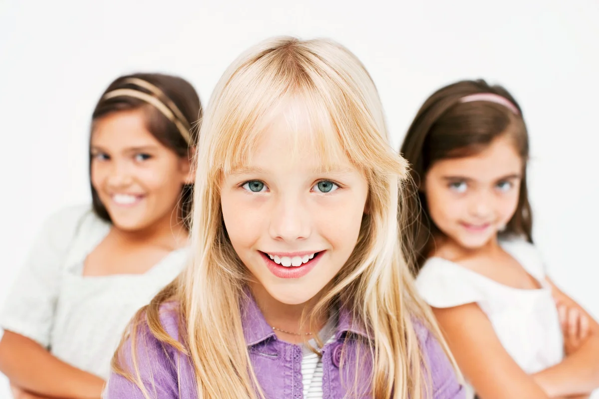 Happy little girl , friends at the back