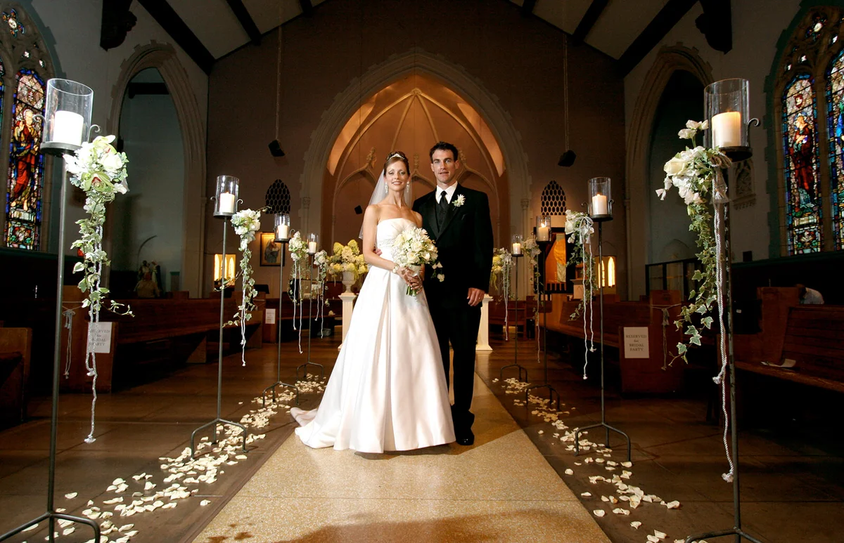 Bride and Groom Couple Inside Old Church Aisle