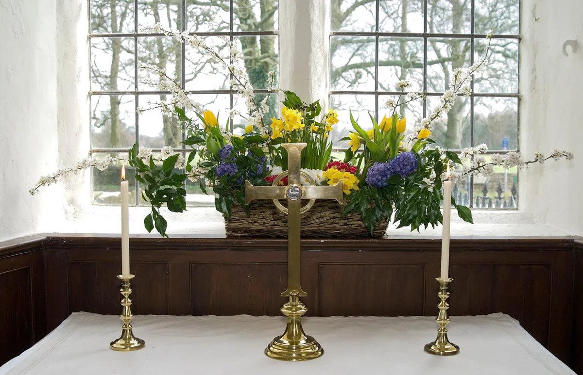 Flowers and candles in front of a window