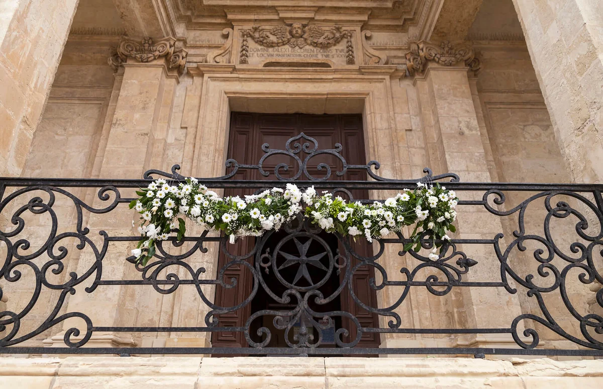Adorned with flowers balcony of the Church of St Catherine , Valletta