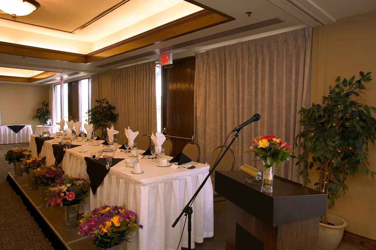 Podium with microphone next to wedding table