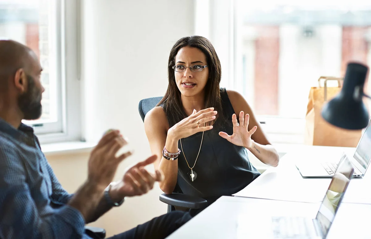 Woman and man talking in modern office