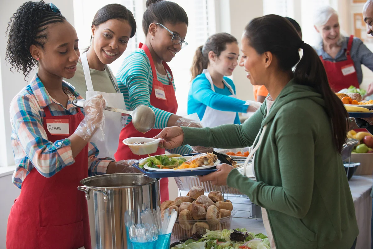 Teens volunteering serving soup
