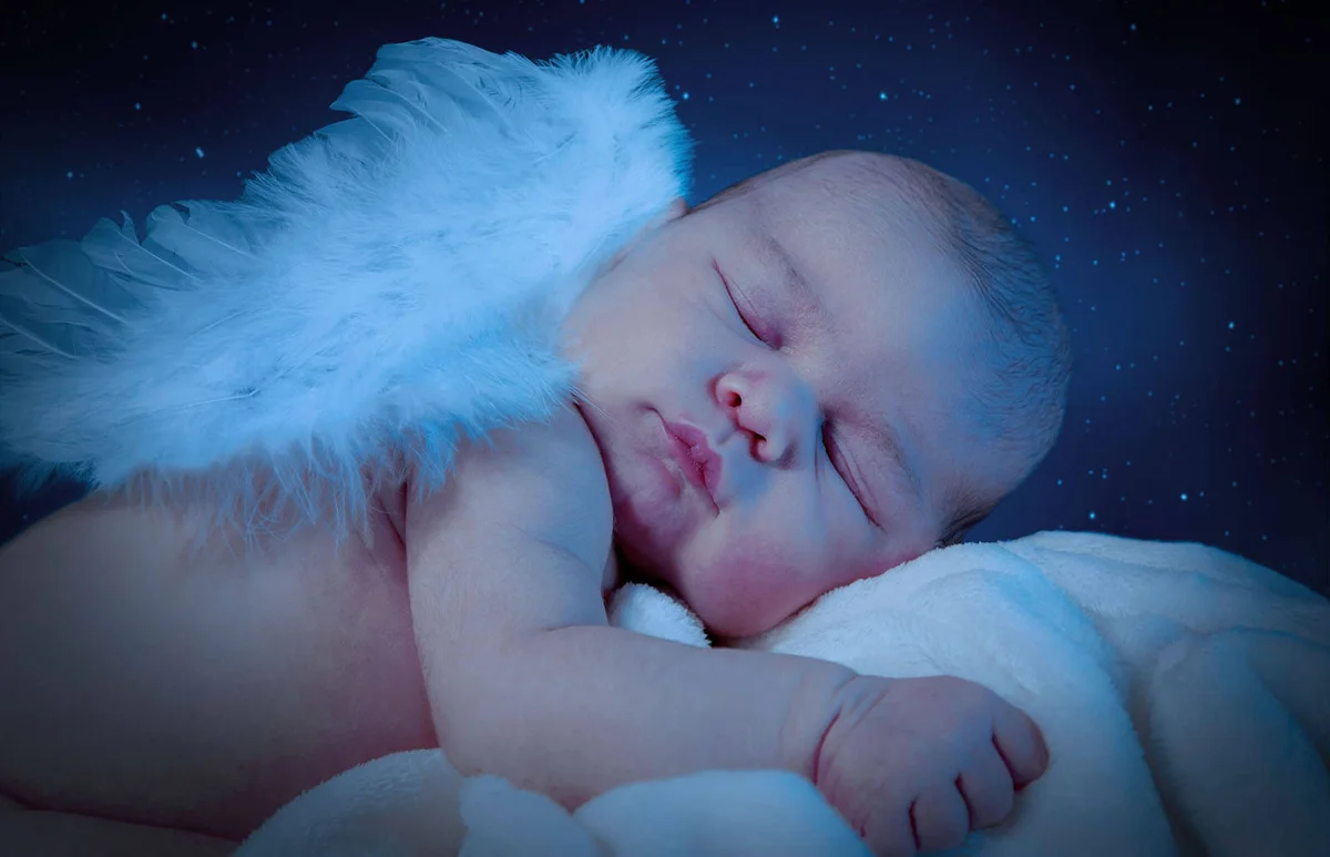 Cute Naked Baby With Wings Sleeping On Bed