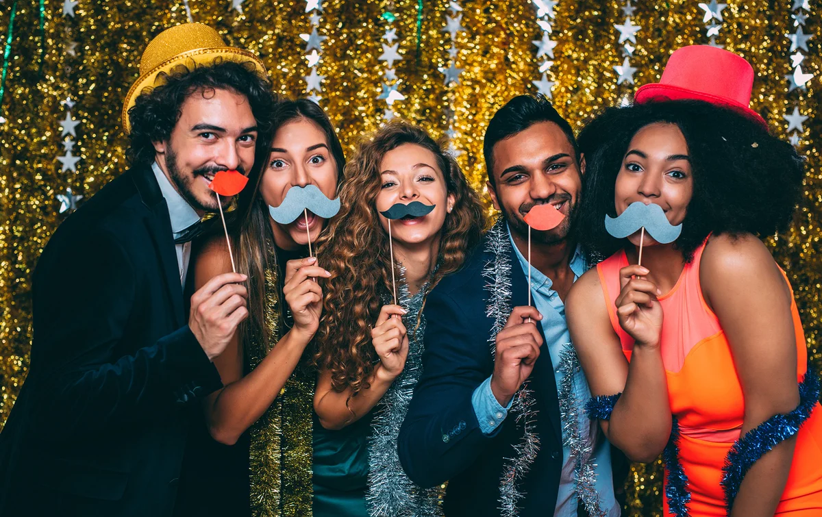 Friends goofing around with fake moustaches
