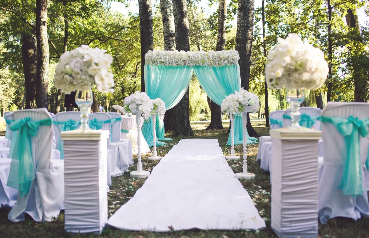 Tulle decor of a wedding ceremony in blue summer colors in the park