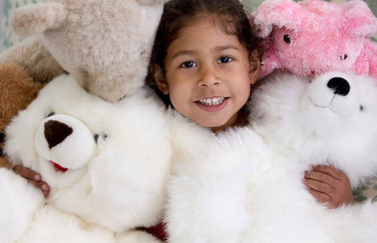 Girl buried under stuffed animals