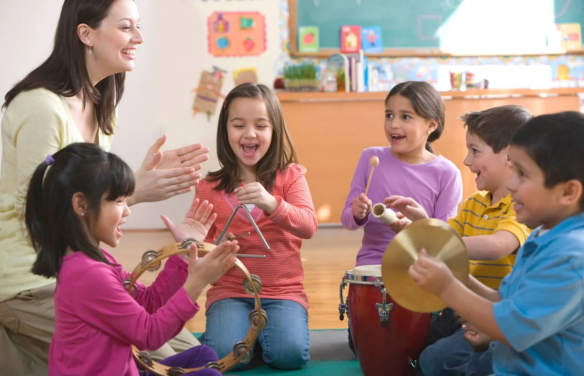 Students playing musical instruments in classroom