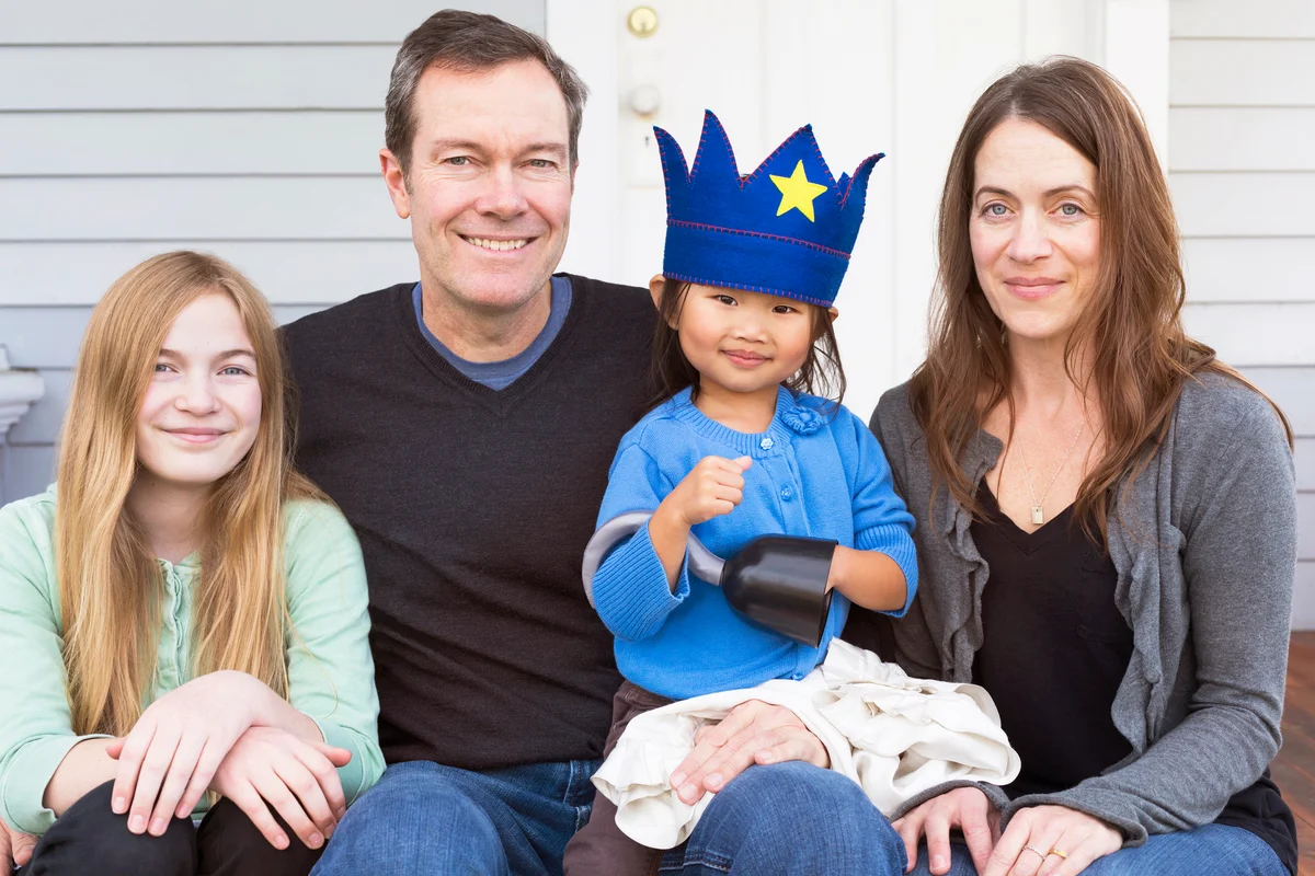 Family with adoptive kid posing and smiling