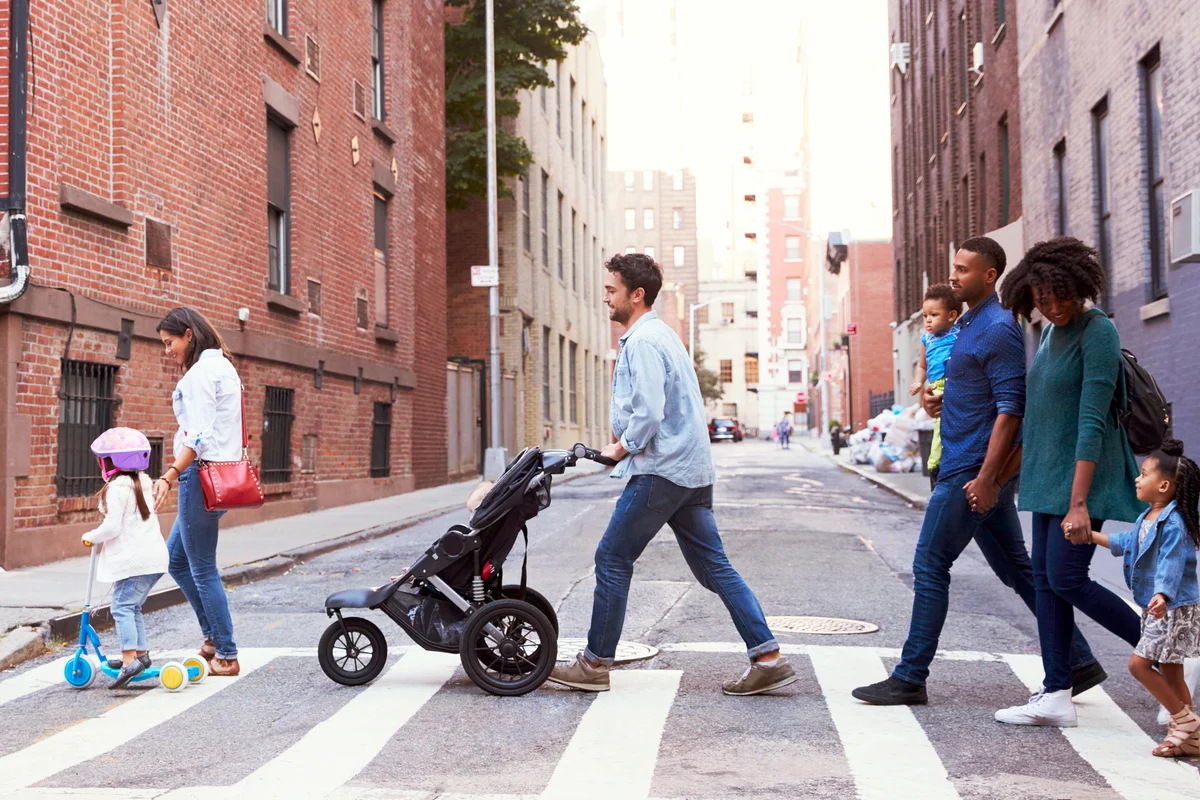 Two families with kids crossing road