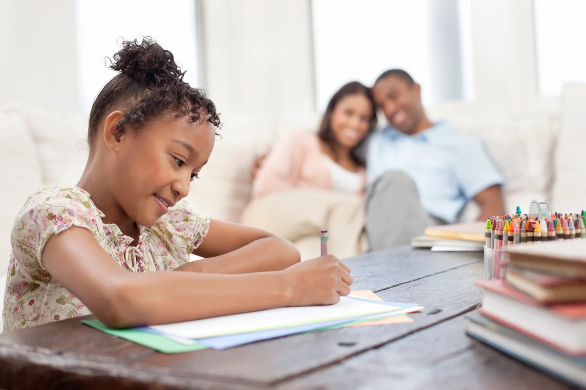 Girl doing homework in sitting room