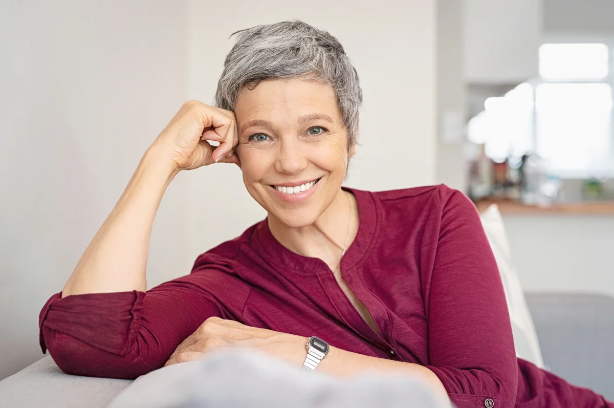 Happy senior woman on couch
