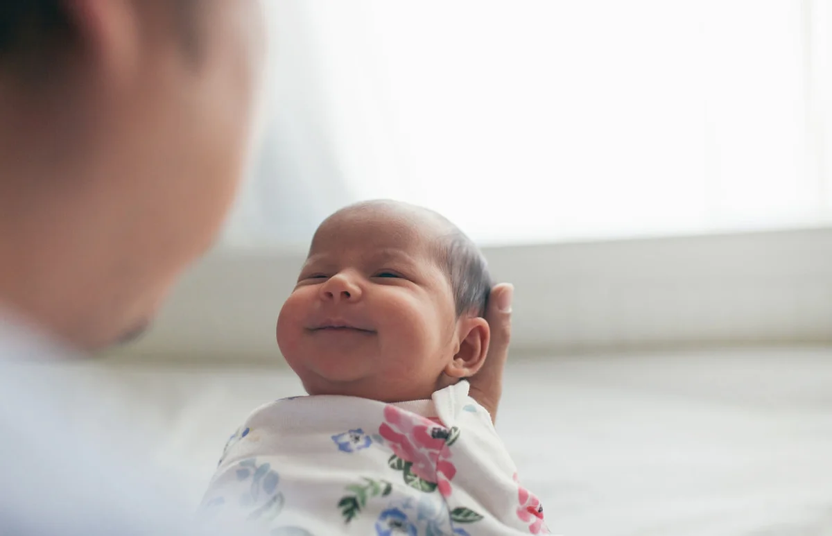 Father holding newborn daughter