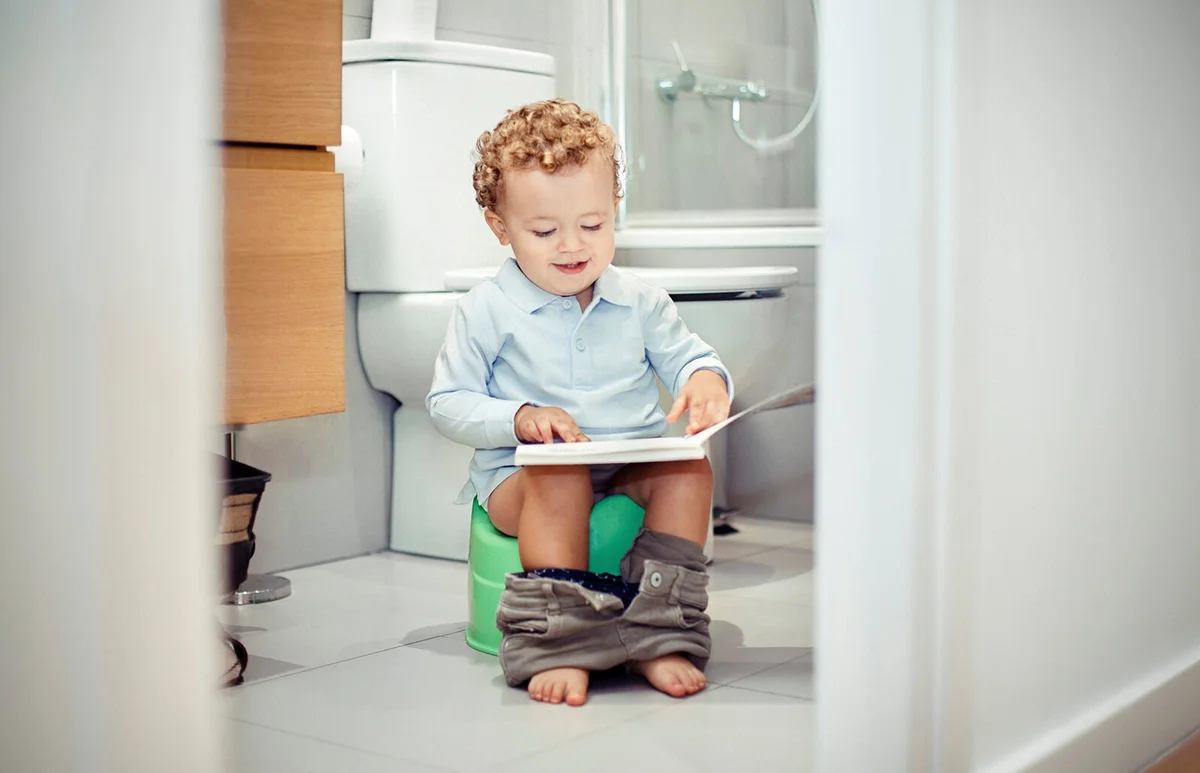 Child sitting on potty chair