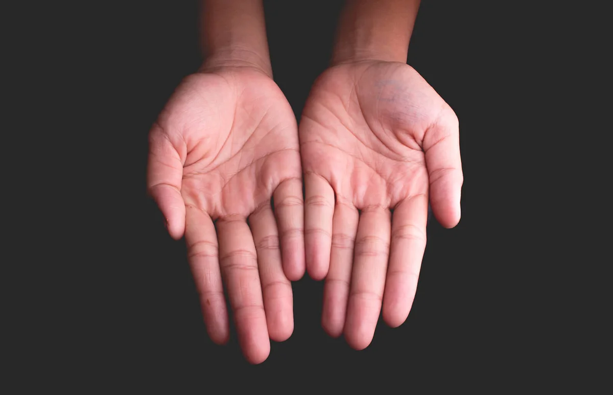 Cropped Hands Against Black Background