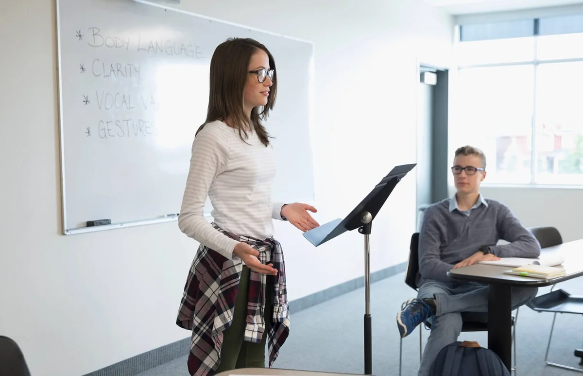 Girl student speaking in debate club in classroom