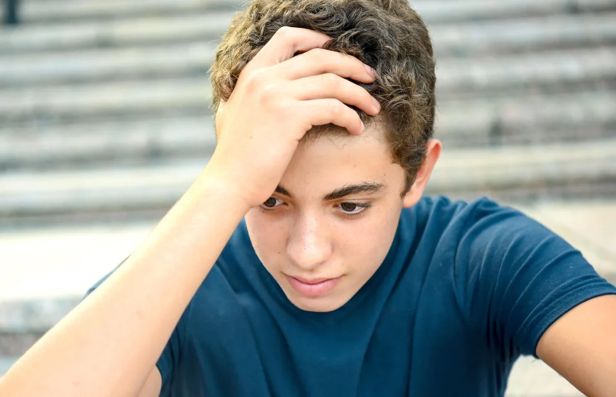 Portrait of a posing pensive male teenager