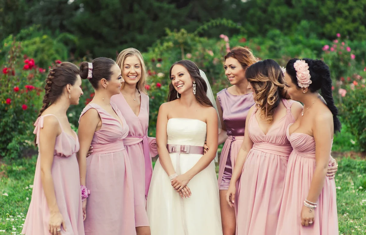 Bride with bridesmaids in pink dresses for a walk