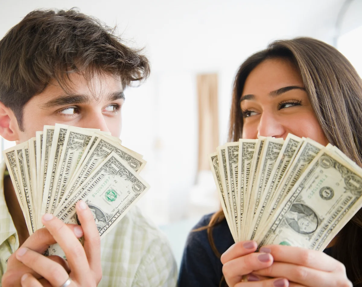 couple holding paper money