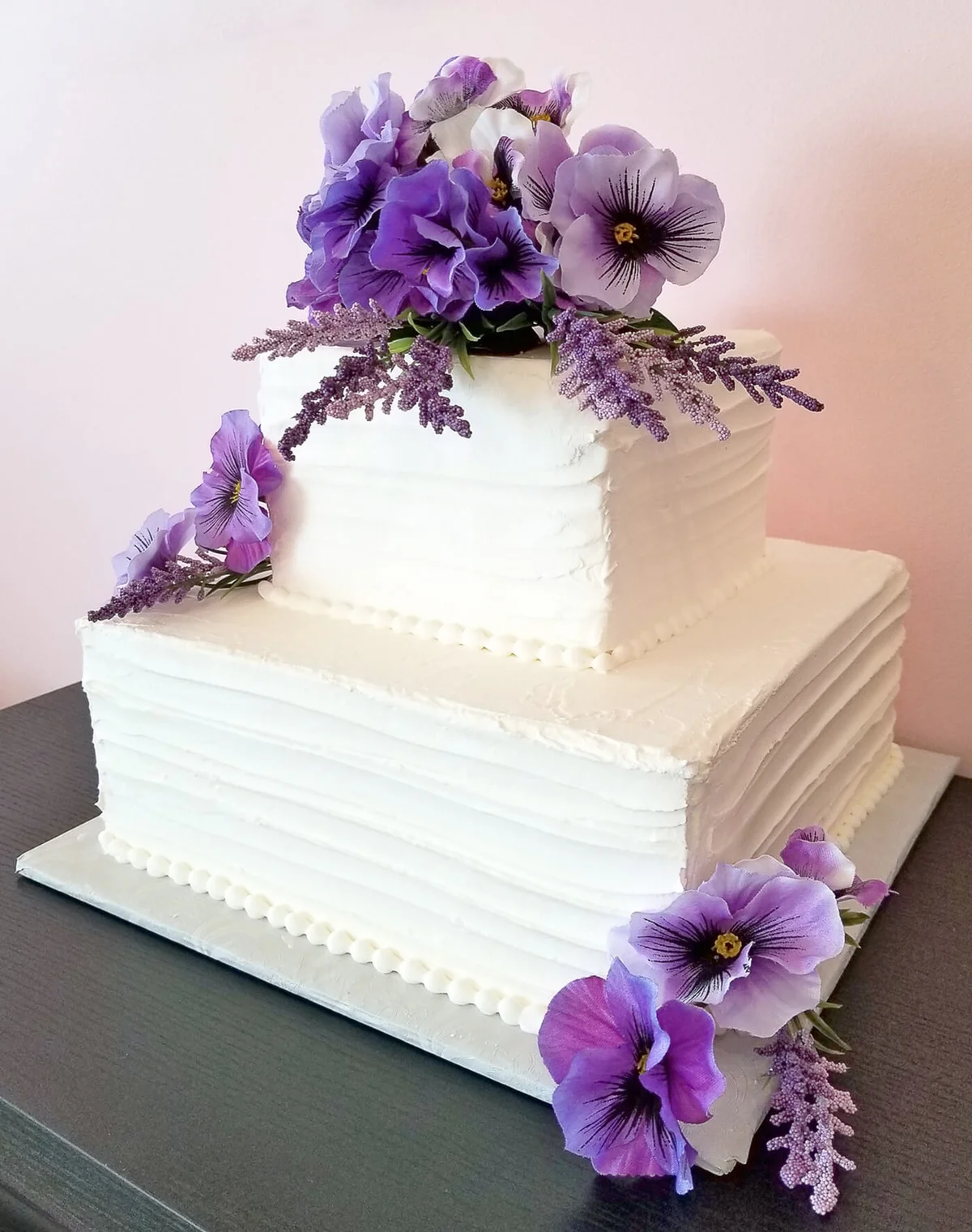 pansy bouquet on tiered square cake