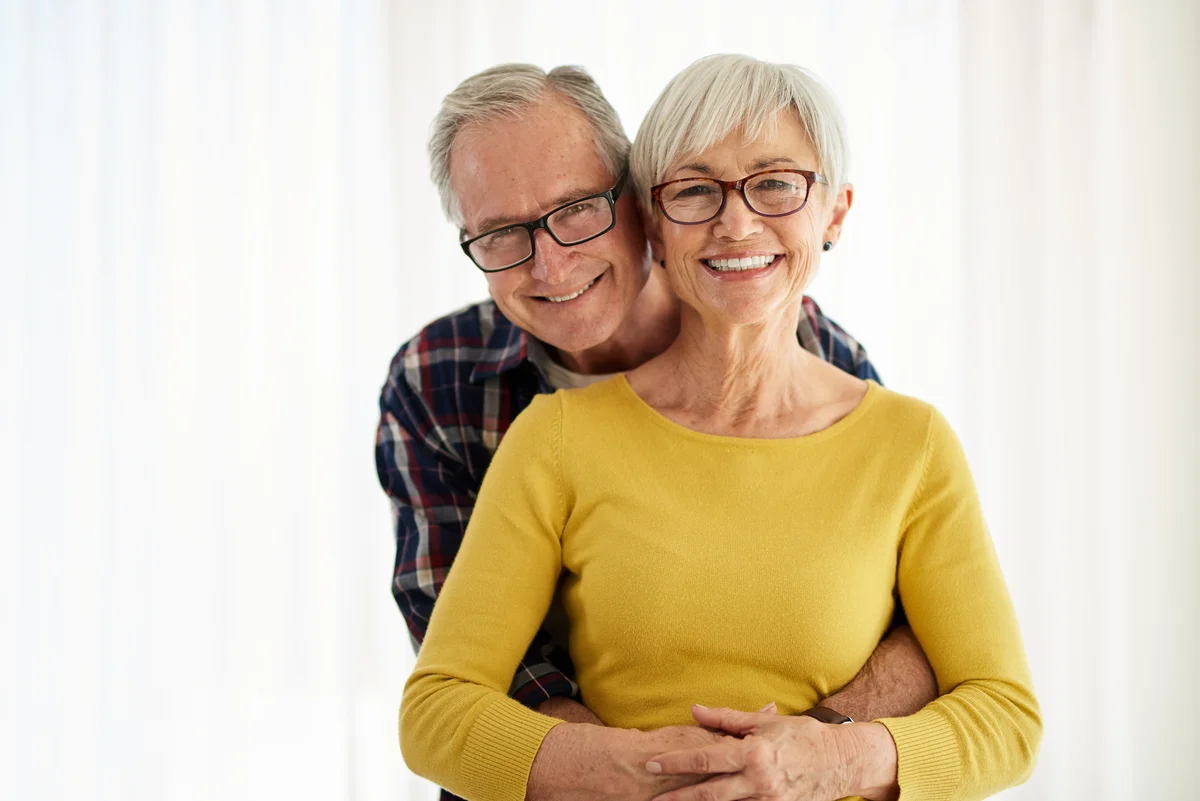 Smiling older couple embracing