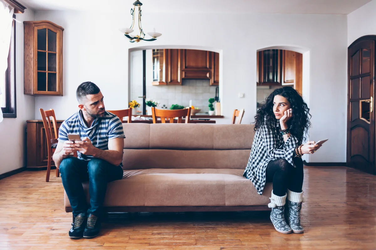 Couple on opposite ends of sofa
