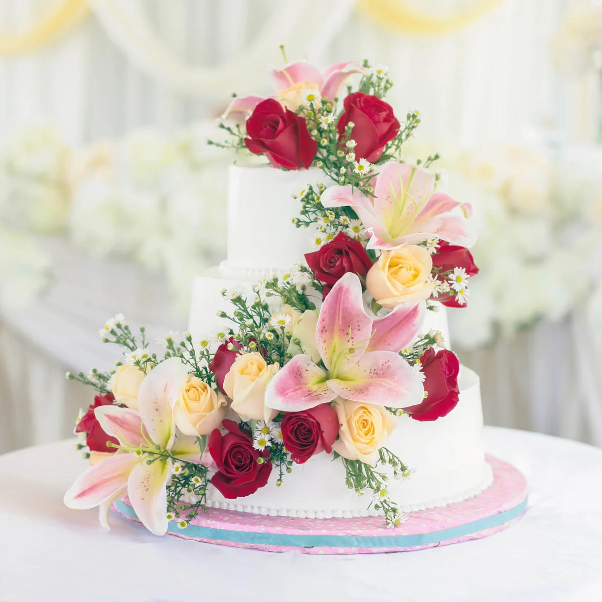 Flowers On Wedding Cake Over Table
