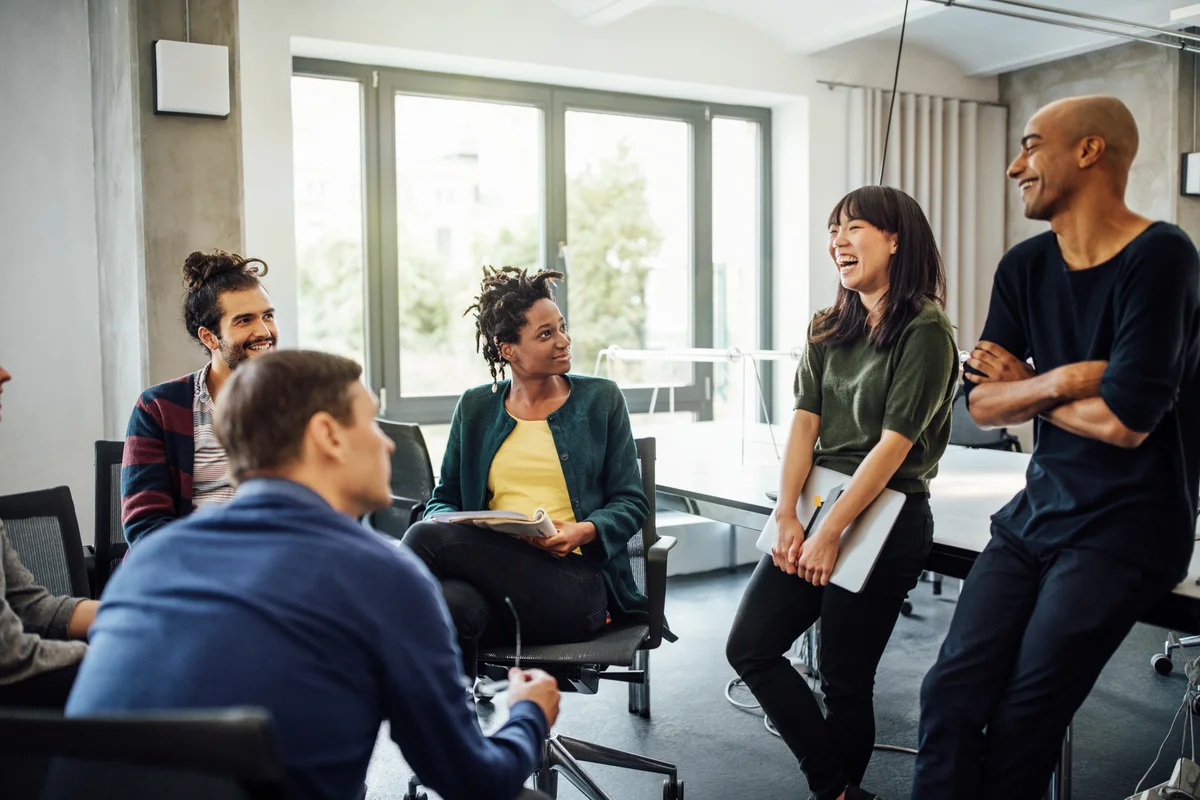 Woman laughing with co-workers
