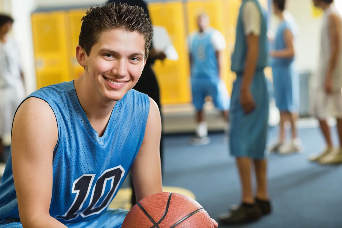 Teen basketball player in locker room
