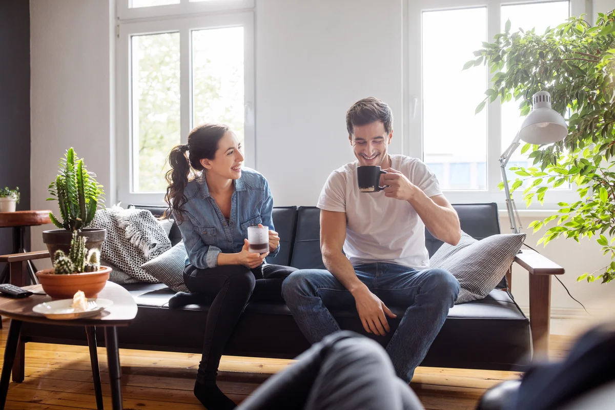 Couple having coffee and laughing