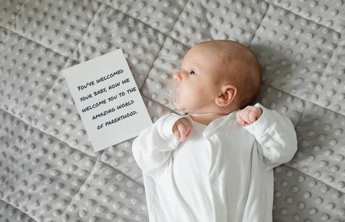 One month old baby with card