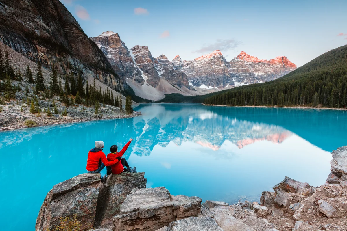 Adventurous couple by a glacier lake