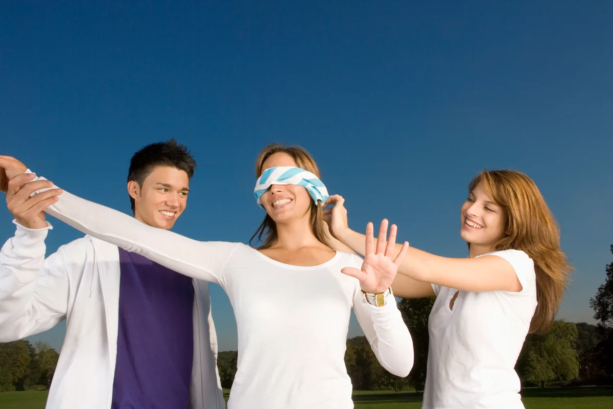 Teens playing blindfold game